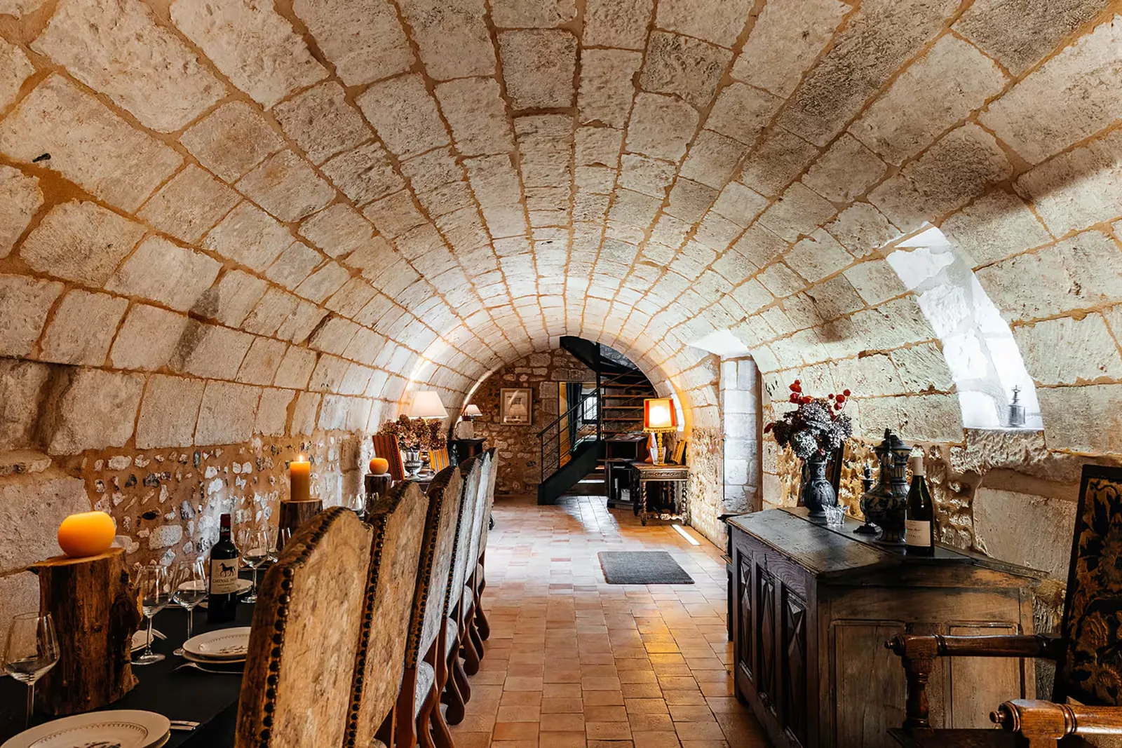 Grande salle voûtée en pierre blanche du XVIIe siècle avec longue table dressée, La Motte Féodale