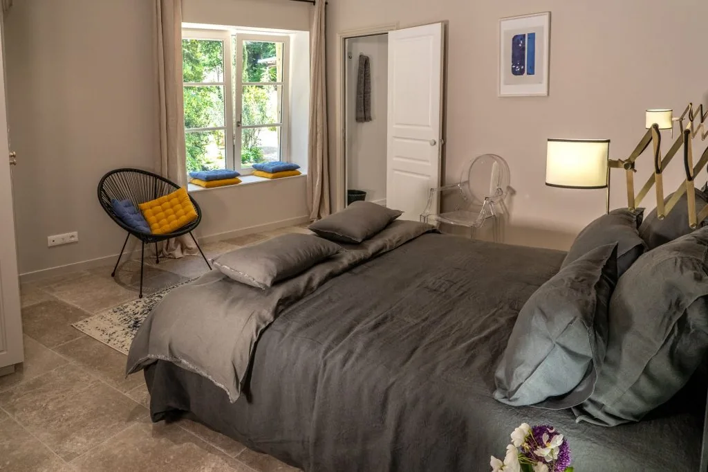 Bright bedroom with a double bed and grey linen bedding, Le Clos d'Abrigeon
