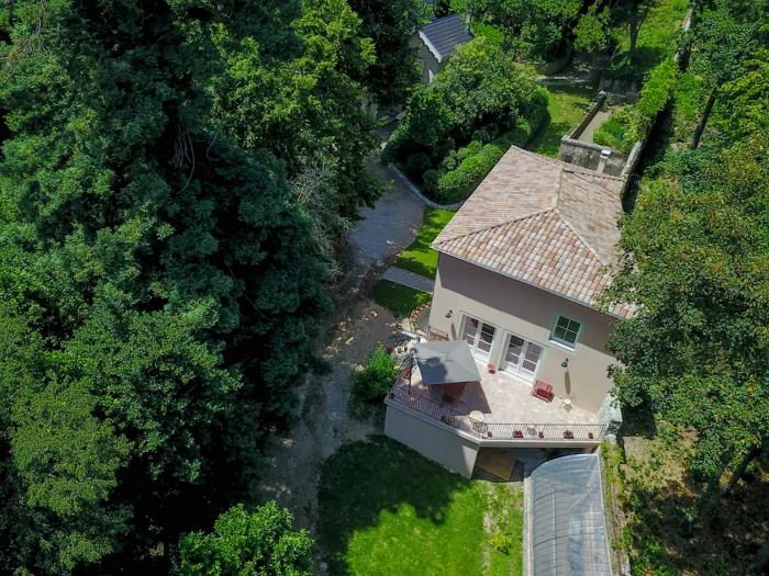 Aerial view of Le Clos d'Abrigeon holiday home and its terrace, in a wooded park in Aubenas
