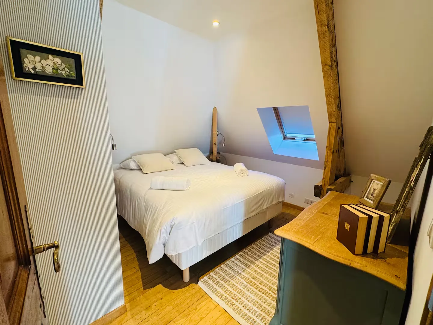 Chambre sous les combles avec grand lit, fenêtre de toit et poutre apparente, Le Clos du Veneur