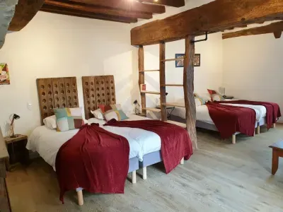 Large ground-floor bedroom with single beds and old beams, Logis Escale