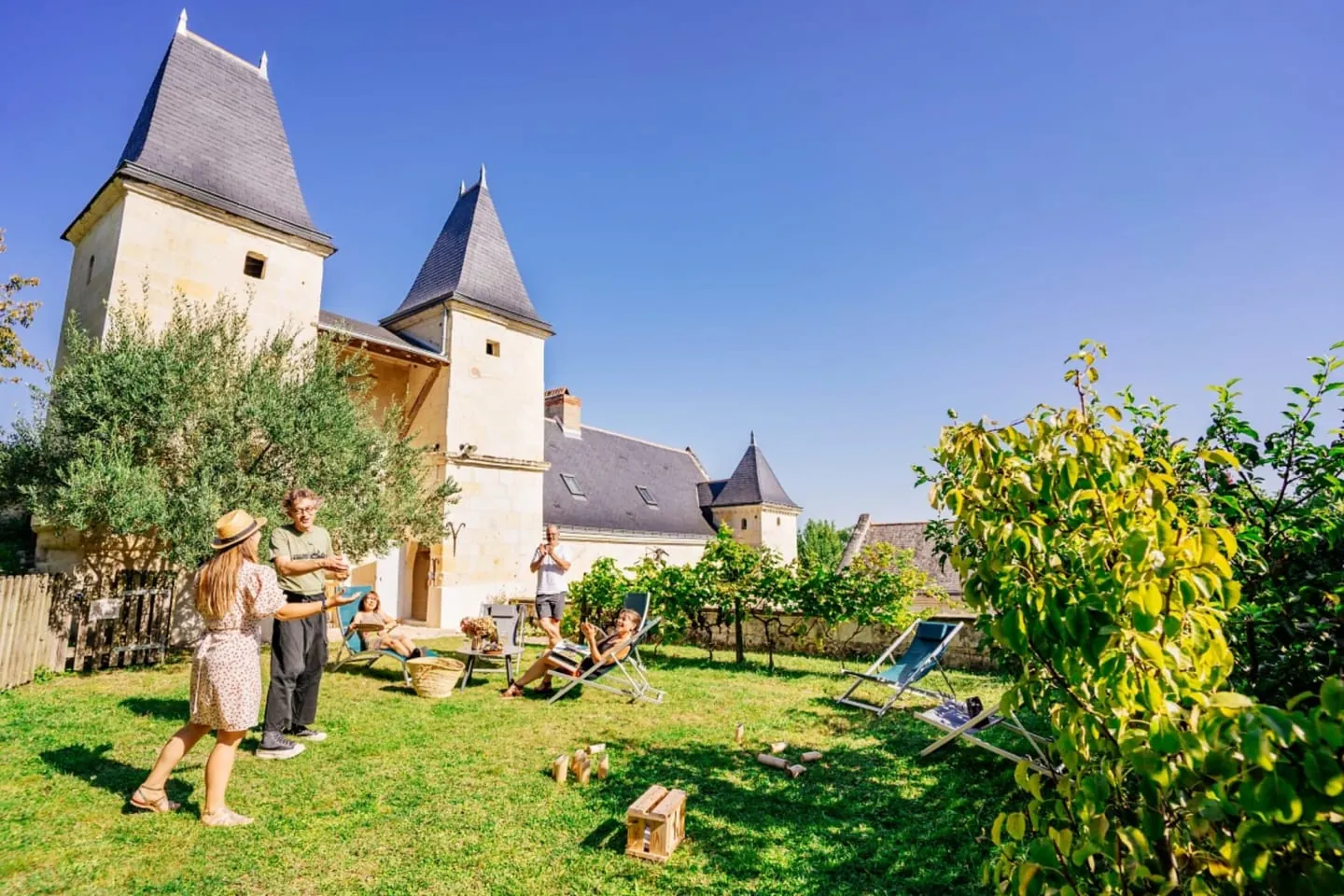 Games and deckchairs in the garden below the towers of Logis Escale