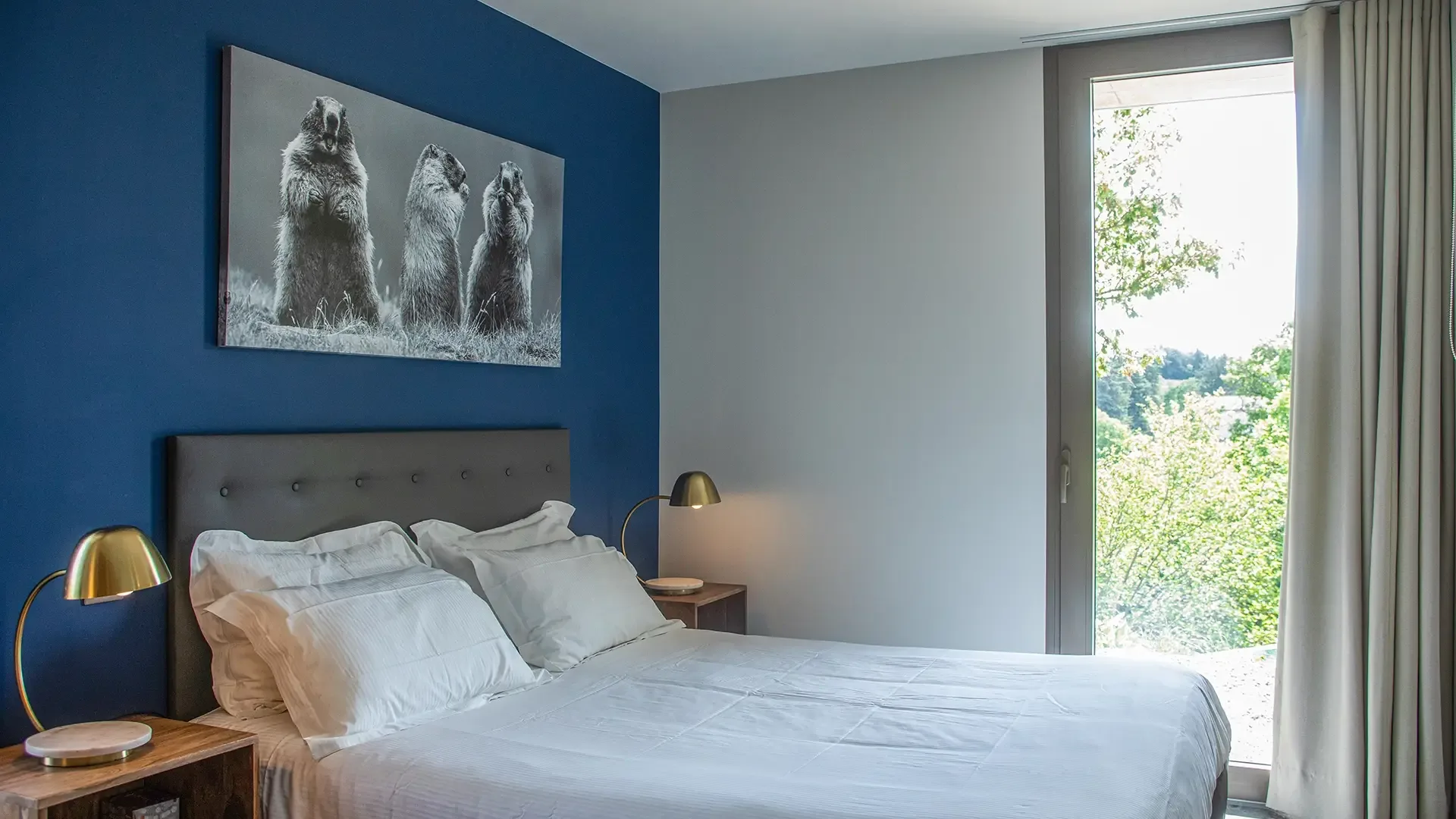 Bedroom with blue wall, 160 cm bed and tall window onto the garden, Maison Chassel in Balazuc