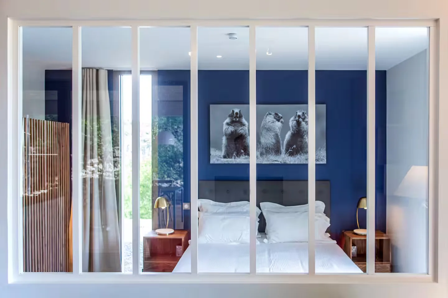 Bedroom seen through the workshop-style glass partition, Maison Chassel gîte
