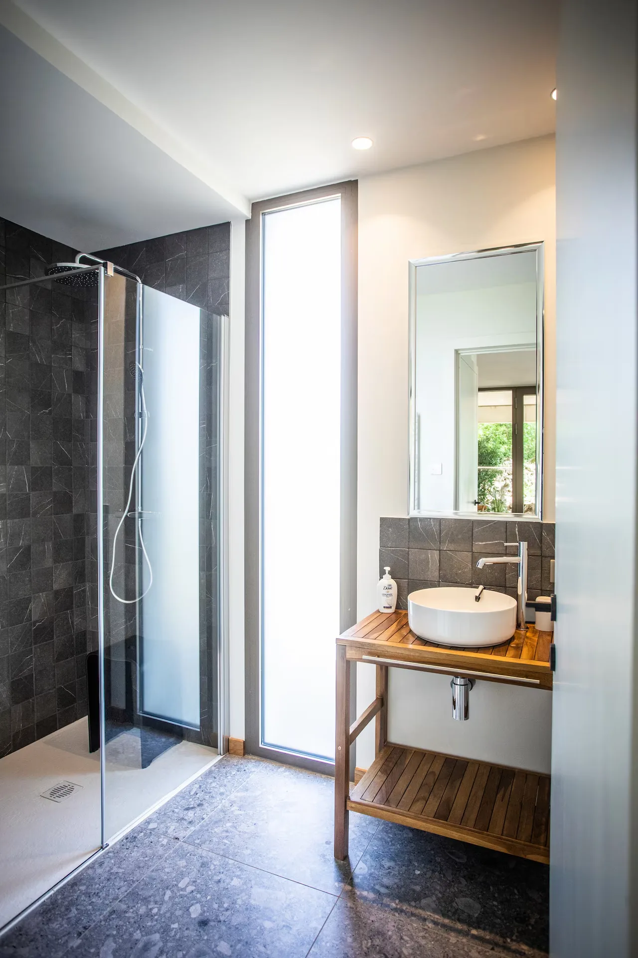 Bathroom with large walk-in shower and basin on a wooden unit, Maison Chassel
