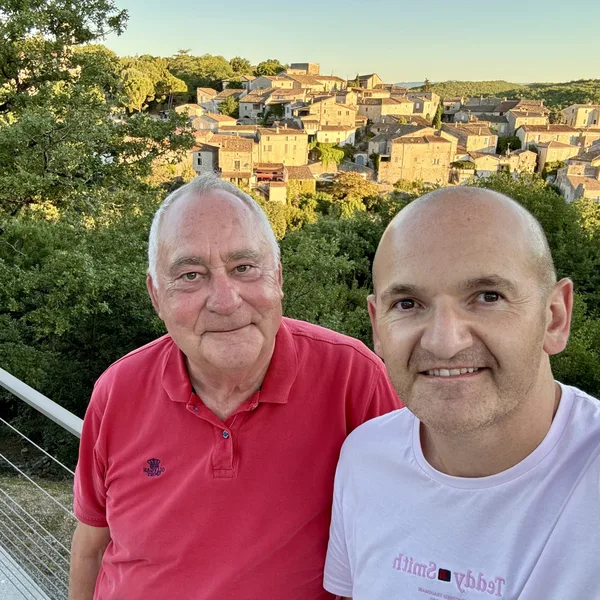 Luc, host of Le Gîte de la Maison Chassel, with Charles from Gemlidays facing the village of Balazuc